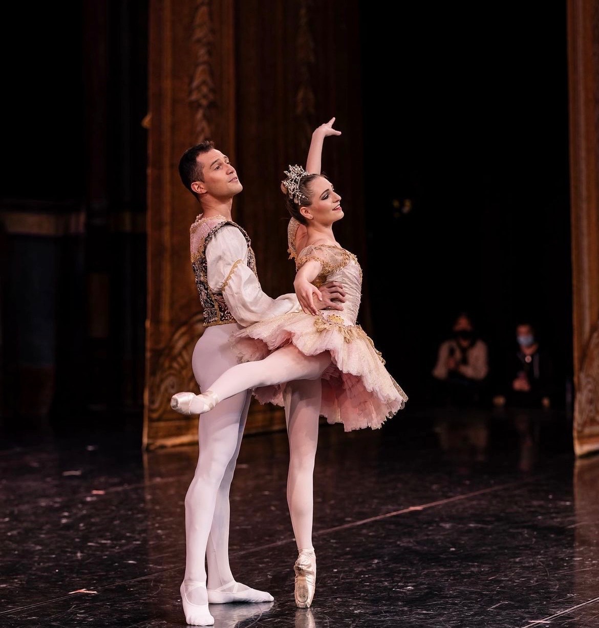 Dancers in blush and gold costumes on stage